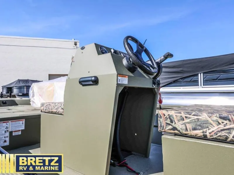 Slide: The Image of 2025 Roughneck RX1860 Tunnel Jet center console with steering wheel, showcased at Bretz RV & Marine. - 11