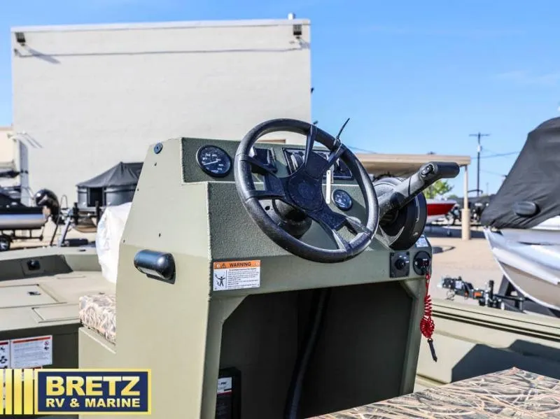 Slide: The Image of 2025 Roughneck RX1860 Tunnel Jet center console with steering wheel at Bretz RV & Marine. - 12