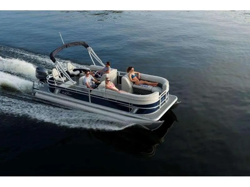 Slide: The Image of 2025 Vista Fish 18 pontoon boat cruising with passengers on a calm lake. - 1