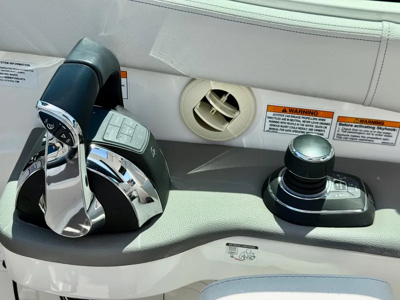 Slide: The Image of Control panel of 2022 Sea Ray Sundancer 320 OB with throttle and joystick. - 2