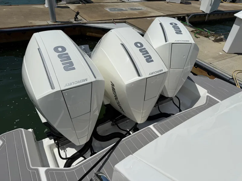 Slide: The Image of Triple Mercury outboard engines on a 2022 Sea Ray Sundancer 320 OB at a dock. - 5