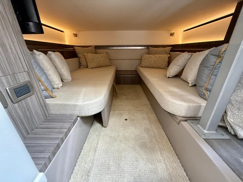 Slide: The Image of 2022 Sea Ray Sundancer 320 OB cabin interior with twin beds and plush cushions. - 7