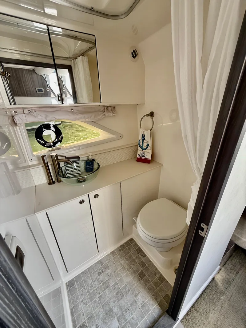 Slide: The Image of 2022 Sea Ray Sundancer 320 OB bathroom with modern fixtures and nautical decor. - 8