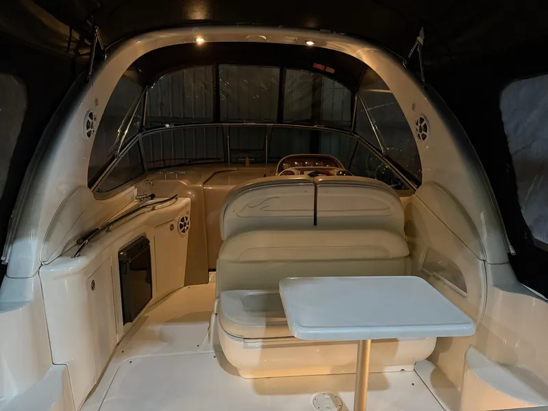 Slide: The Image of 2004 Sea Ray 300 Sundancer interior with seating and table, showcasing luxury boat design. - 14