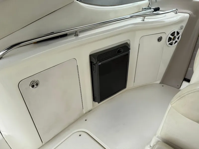Slide: The Image of 2004 Sea Ray 300 Sundancer interior with storage compartments and speaker. - 17