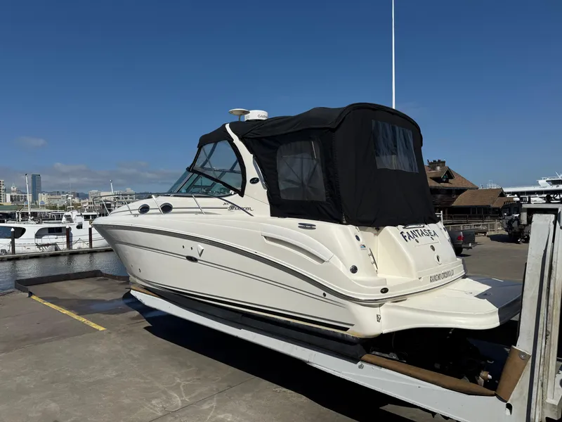 Slide: The Image of 2004 Sea Ray 300 Sundancer boat docked at marina under clear blue sky. - 2