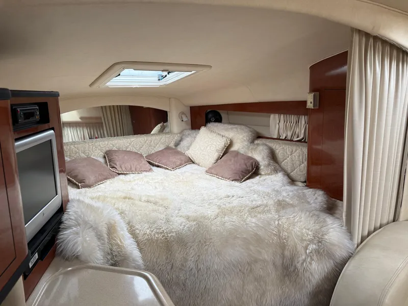 Slide: The Image of Luxurious cabin interior of 2004 Sea Ray 300 Sundancer with plush bedding and modern amenities. - 20