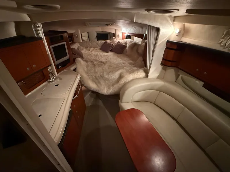 Slide: The Image of Luxurious interior of 2004 Sea Ray 300 Sundancer yacht with cozy seating and plush bedding. - 21