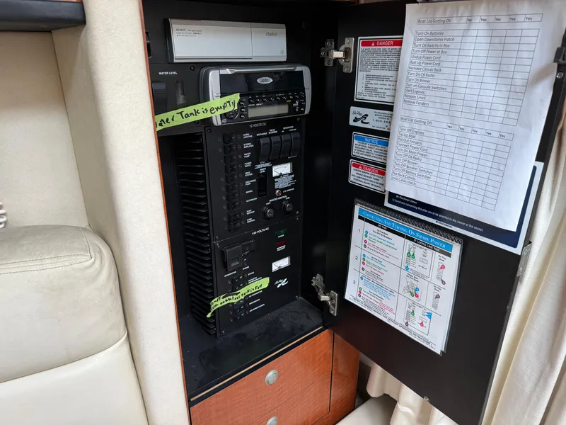 Slide: The Image of Control panel inside a 2004 Sea Ray 300 Sundancer boat, featuring various switches and labels. - 27
