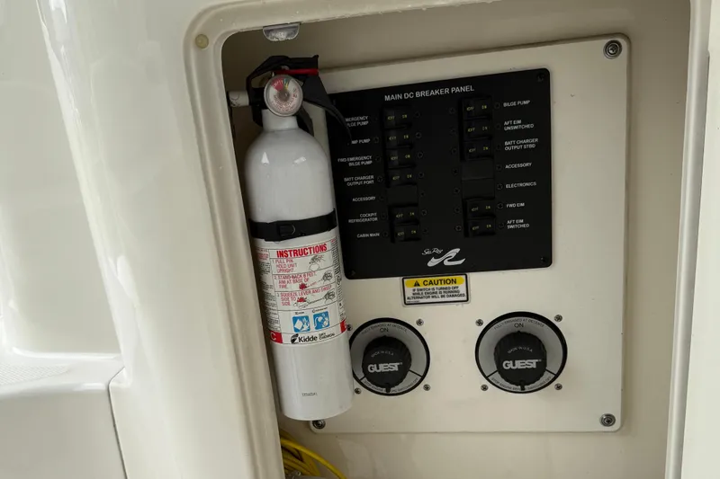 Slide: The Image of Fire extinguisher and control panel on 2004 Sea Ray 300 Sundancer boat. - 29
