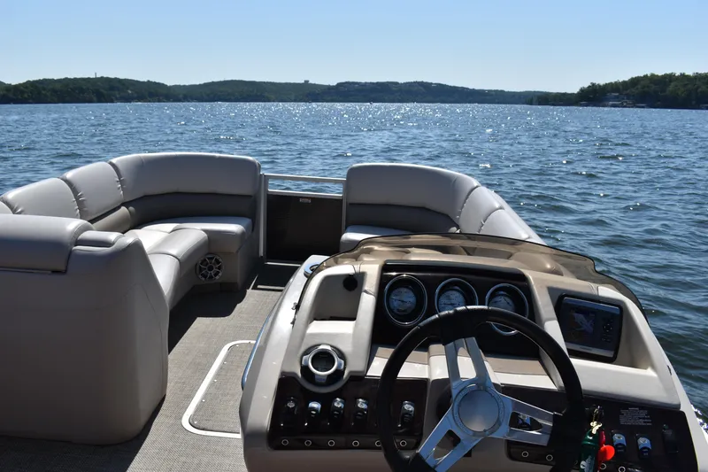 Slide: The Image of 2013 Bennington 2575 QCW I/O pontoon boat on a scenic lake. - 14