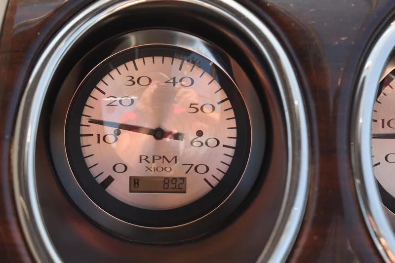 Slide: The Image of Close-up of a 2013 Bennington 2575 QCW I/O RPM gauge displaying 892 RPM. - 15