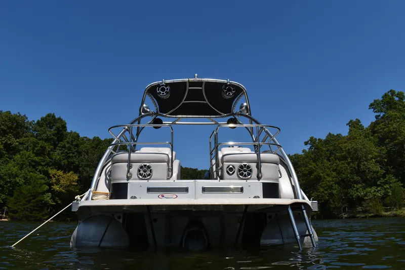 Slide: The Image of 2013 Bennington 2575 QCW I/O boat on a lake, surrounded by trees. - 18