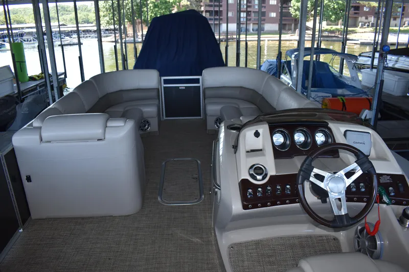 Slide: The Image of 2013 Bennington 2575 QCW I/O pontoon boat interior with steering console and seating. - 23
