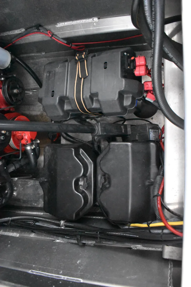 Slide: The Image of Engine compartment of a 2013 Bennington 2575 QCW I/O with visible battery and wiring. - 26