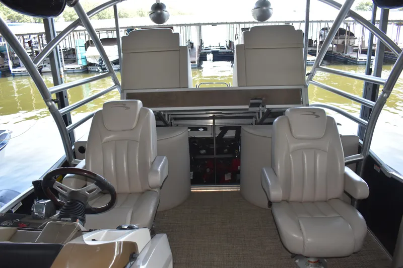 Slide: The Image of 2013 Bennington 2575 QCW I/O boat interior with plush seating and steering wheel. - 29