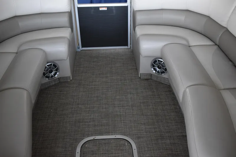 Slide: The Image of 2013 Bennington 2575 QCW I/O boat interior with gray seating and carpeted floor. - 32