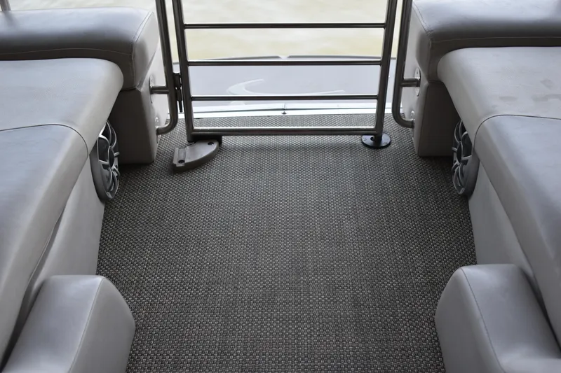 Slide: The Image of 2013 Bennington 2575 QCW I/O boat interior with gray seating and carpet flooring. - 35