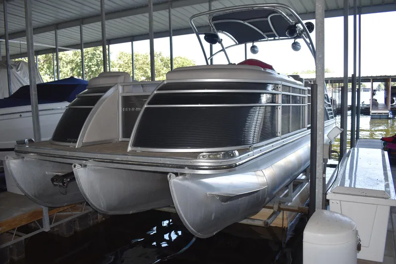 Slide: The Image of 2013 Bennington 2575 QCW I/O pontoon boat docked in covered marina. - 39
