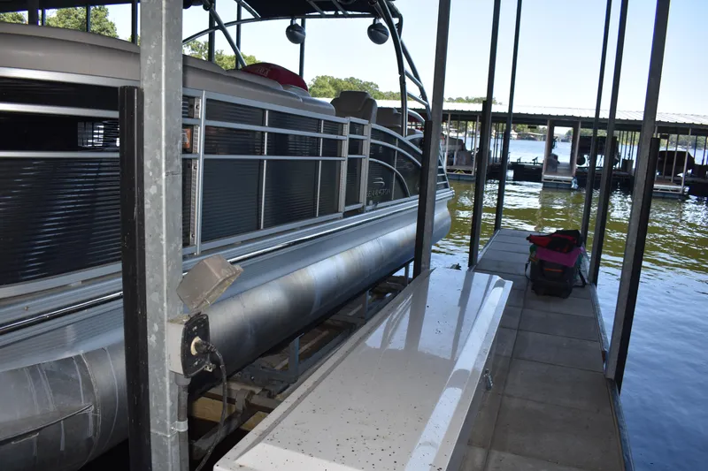 Slide: The Image of 2013 Bennington 2575 QCW I/O pontoon boat docked in a marina. - 41