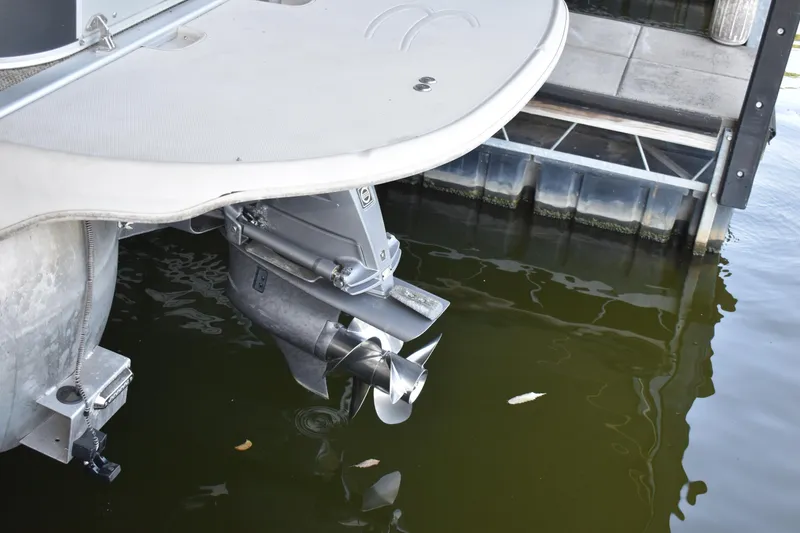 Slide: The Image of 2013 Bennington 2575 QCW I/O boat propeller in water, docked at marina. - 43
