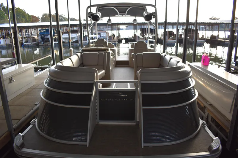 Slide: The Image of 2013 Bennington 2575 QCW I/O pontoon boat docked in a marina. - 5