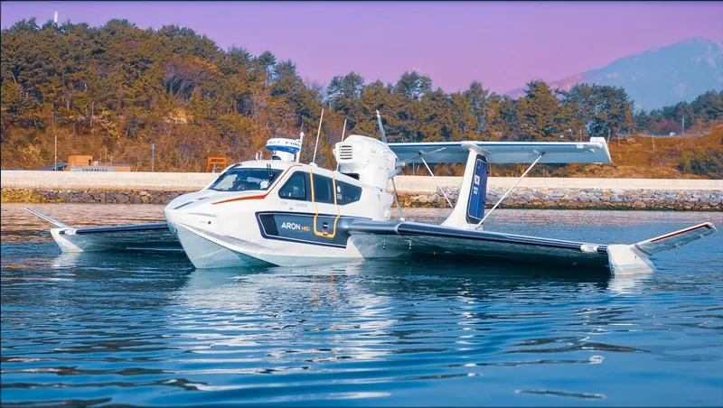 Slide: The Image of Seaplane Aron M 80, 2025 model, floating on water with scenic background. - 3