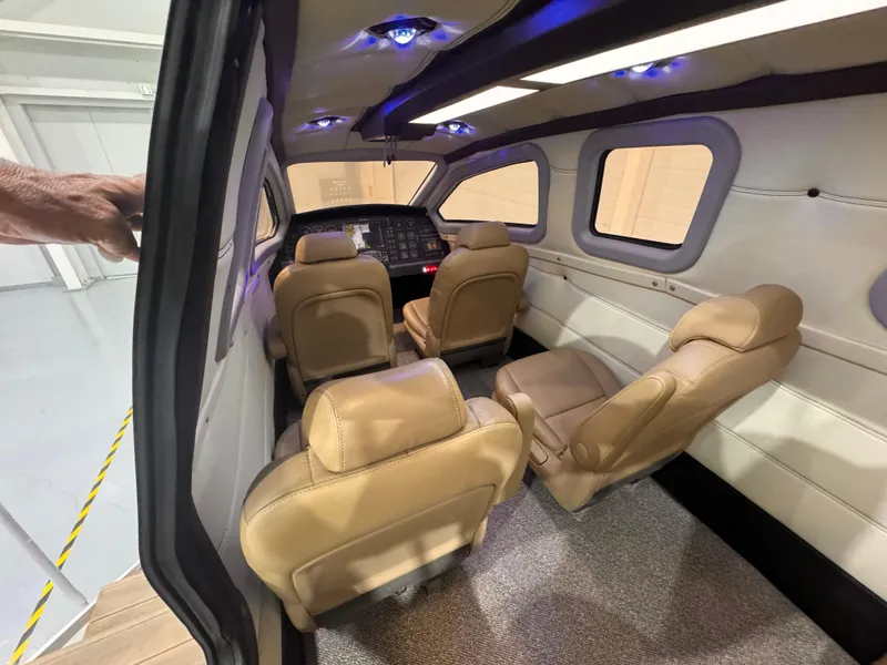 Slide: The Image of Interior of Aron M 80 aircraft, 2025 model, featuring beige leather seats and modern cockpit. - 8