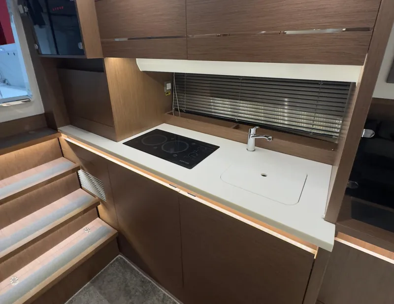 Slide: The Image of Modern kitchen area in 2021 Jeanneau Leader 12.5 WA yacht with stovetop and sink. - 12