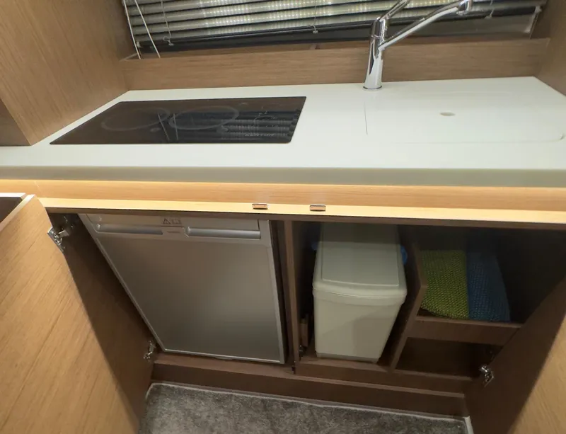 Slide: The Image of Modern kitchen area in 2021 Jeanneau Leader 12.5 WA boat with stove and storage. - 13