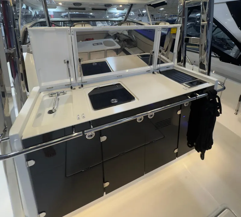 Slide: The Image of 2021 Jeanneau Leader 12.5 WA boat kitchen area with sink and storage cabinets. - 15
