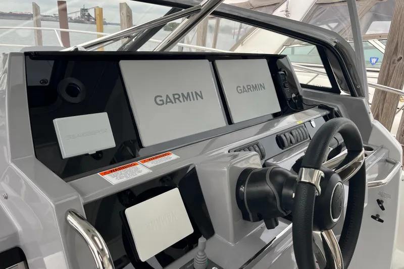 Slide: The Image of 2021 Jeanneau Leader 12.5 WA helm with dual Garmin displays and steering wheel. - 17