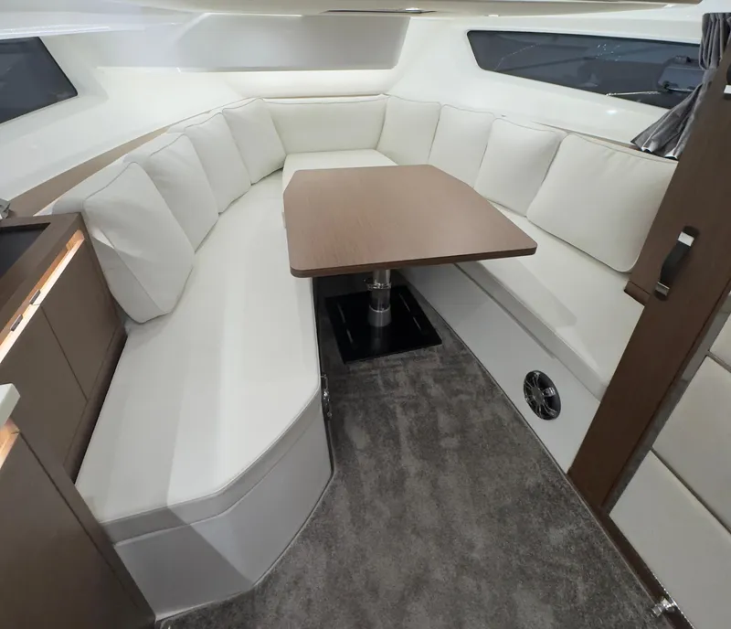 Slide: The Image of Interior of 2021 Jeanneau Leader 12.5 WA boat with cozy seating and table. - 4
