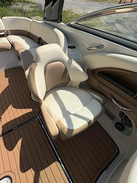 Slide: The Image of 2017 Crownline 285 SS boat interior with beige seating and wood-style flooring. - 12