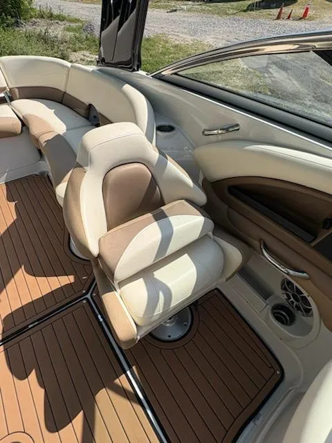 Slide: The Image of 2017 Crownline 285 SS boat interior with beige seating and wood-style flooring. - 13