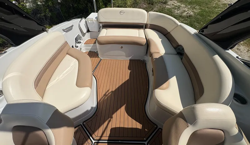 Slide: The Image of 2017 Crownline 285 SS boat interior with beige seating and wood-style flooring. - 18