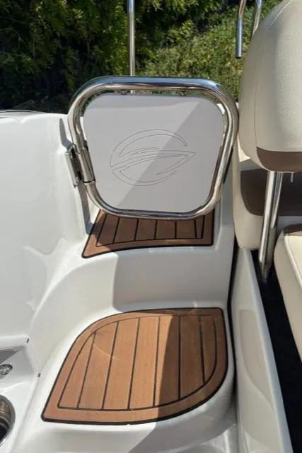 Slide: The Image of 2017 Crownline 285 SS boat interior with teak flooring and stainless steel accents. - 24