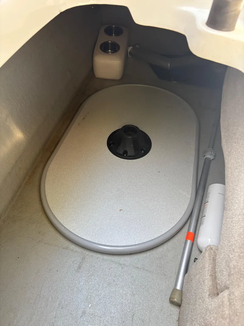 Slide: The Image of 2017 Crownline 285 SS storage compartment with cup holders and equipment. - 28