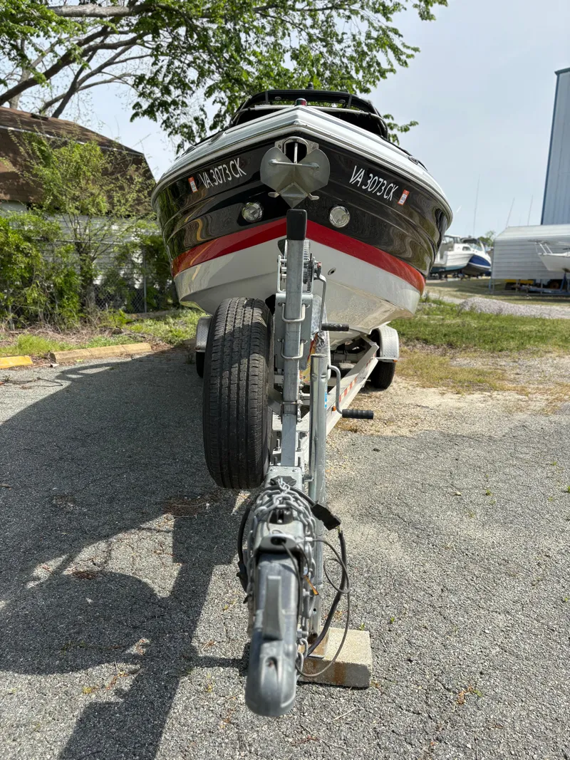 Slide: The Image of 2017 Crownline 285 SS boat on trailer, parked outdoors. - 3