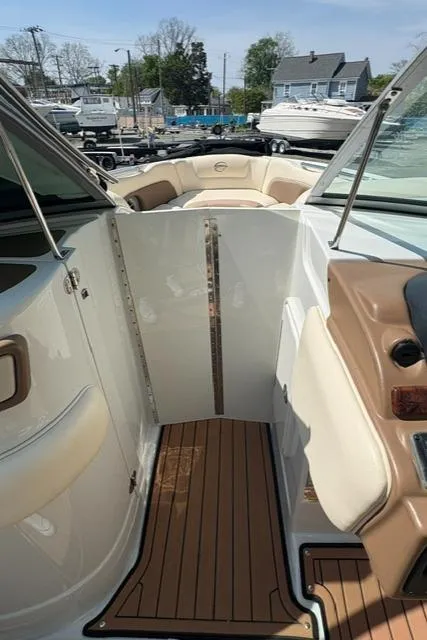 Slide: The Image of 2017 Crownline 285 SS boat interior with seating and wood flooring. - 30