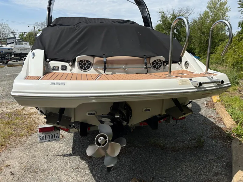 Slide: The Image of 2017 Crownline 285 SS boat rear view with covered deck and dual propellers. - 7
