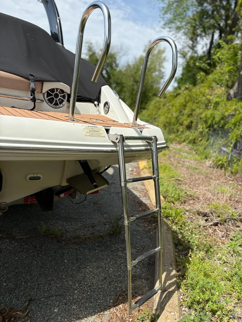 Slide: The Image of Stainless steel ladder on 2017 Crownline 285 SS boat, docked outdoors. - 9