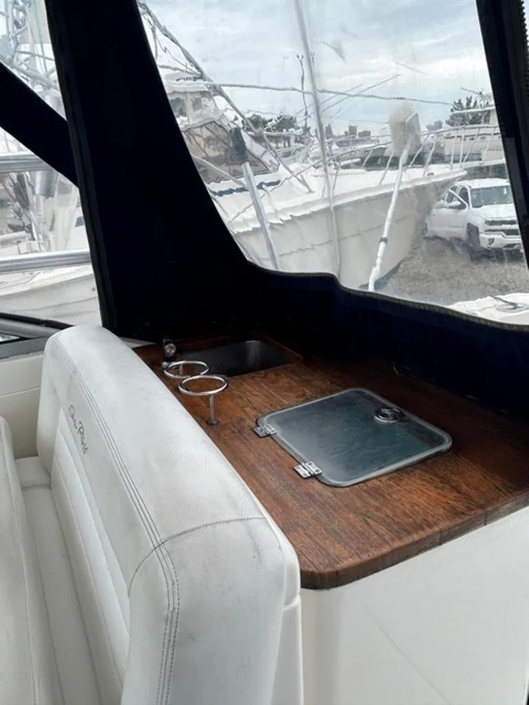 Slide: The Image of 2008 Sea Ray 290 Amberjack interior with sink and countertop, featuring marina view. - 12