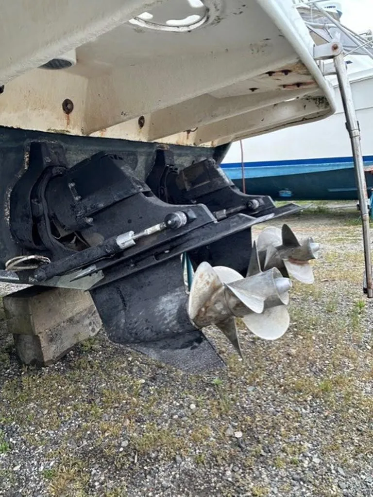 Slide: The Image of 2008 Sea Ray 290 Amberjack boat propellers and stern drive on dry land. - 14