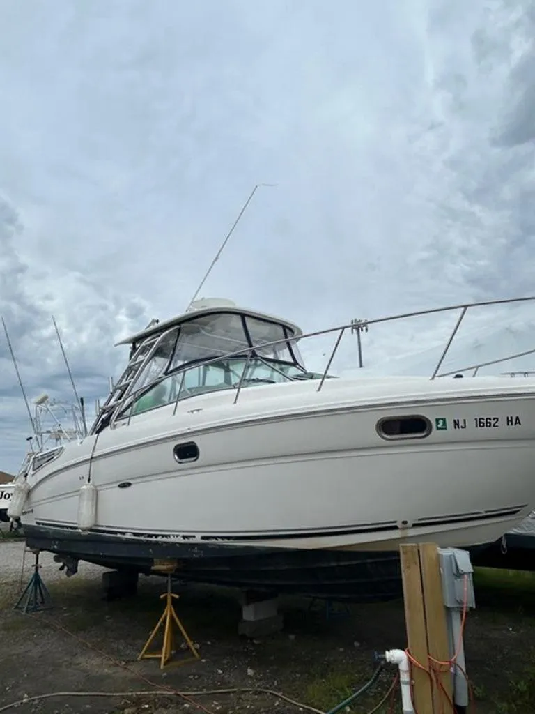 Slide: The Image of 2008 Sea Ray 290 Amberjack boat on stands, cloudy sky background. - 15
