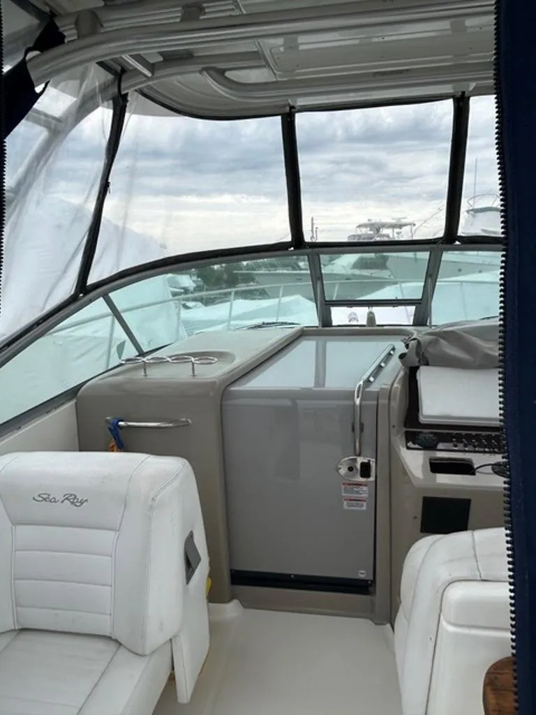 Slide: The Image of 2008 Sea Ray 290 Amberjack boat interior with helm and seating area. - 6