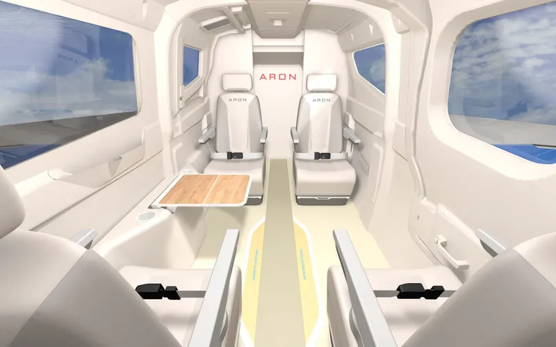Slide: The Image of Interior of Aron M 80, 2025 model, featuring sleek white seats and a wooden table. - 19