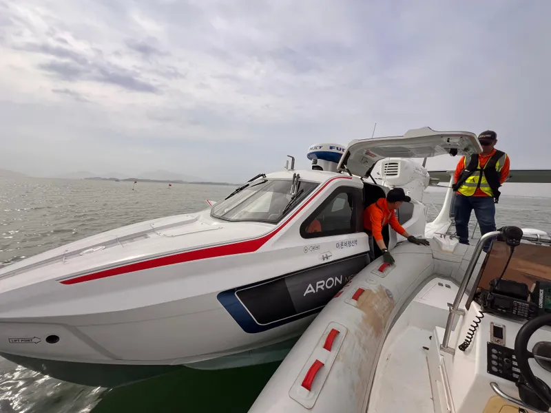 Slide: The Image of 2025 Aron M 80 boat with crew in safety vests on water. - 21