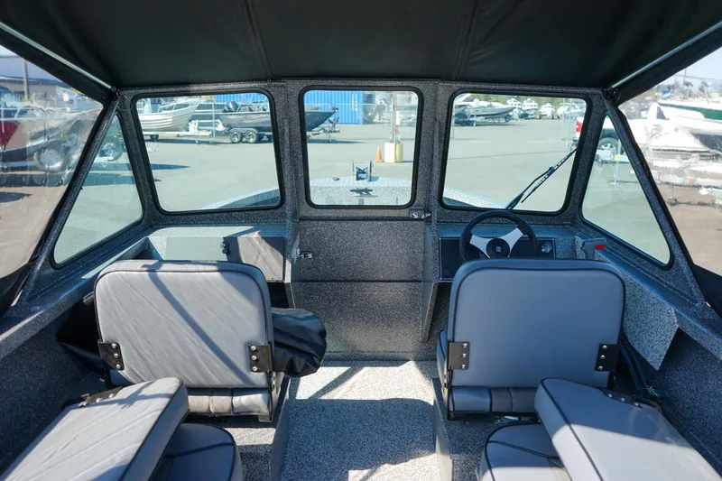 Slide: The Image of Interior view of 2024 Alumaweld Talon 18 boat, featuring seating and steering console. - 11