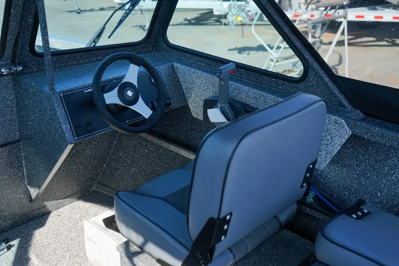 Slide: The Image of 2024 Alumaweld Talon 18 boat interior with steering wheel and seating. - 12